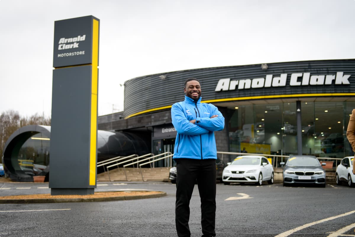 Image of a product consultant outside of an Arnold Clark branch