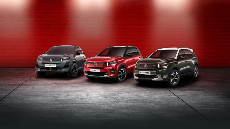 Citroën electric vehicle range under spotlights against a red background