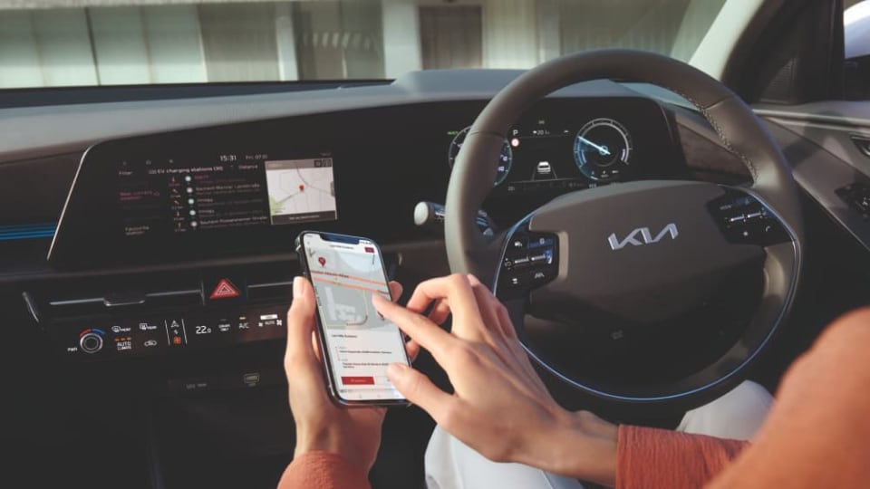 Model using Kia Charge app in Kia vehicle