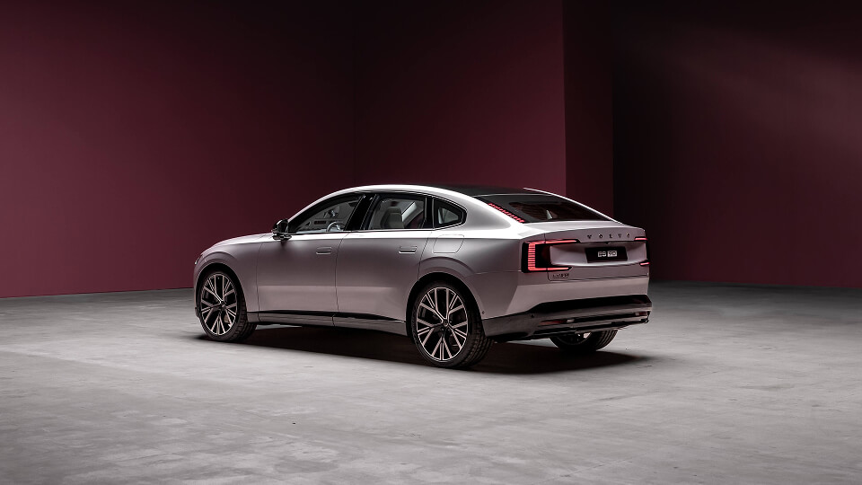 Rear side view of a silver Volvo ES90 in a studio